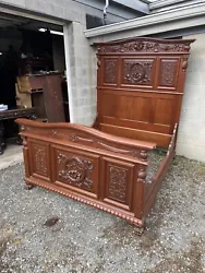 Heavy carved Victorian mahogany bed with claw feet and carved florals, wreaths and bows. The footboard is 41” tall. J...