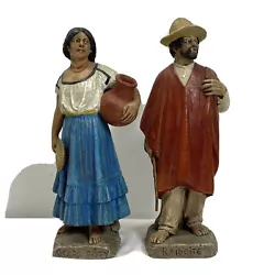 E-0431920s Pair of SERAFIN MARSAL Folk Art Sculptures Paraguay peasant couple, the woman is 7.25” tall Ocara Poty the...