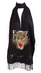 This is a stole scarf by Gucci. It has fringed ends and a large sequined tiger face that is split between two ends of...