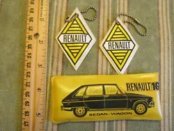 Comb and rain poncho kit. Two key chains, unused, that have been in a box all these decades. They have a slight bend.