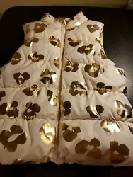 THIS IS A GIRLS PUFFER VEST SIZE 8 WHITE & GOLD FULL ZIP POLY WITH A WHITE FLEESE LINNING THAT MAKES IT VERY SOFT. IT...