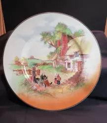 Very attractive plate with a country scene with a man repairing a chair and children. Pretty fall colors. Plate is in...