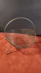 This vintage  wire magazine rack is a unique addition to any mid-century modern collection. With atomic sub-style and...