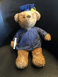 There is an elastic loop on the right paw where you can roll money and present it to the graduate. See picture. I use a...