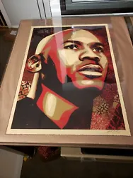 Signed by Fairey and numbered out of 123. New Kraft, new piece of glassine over image, one piece of non stick artist...