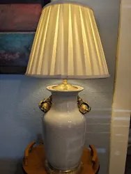 The lamp features a cream color crackle porcelain with beautiful bronze accents such as bronze rose bud handles base...