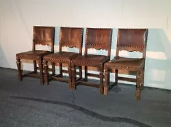 Great set of 4 carved Spanish revival wood dining side chairs, leather seats. Studs coming out. Lots of wear to...