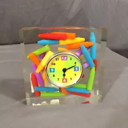 It’s made of clear acrylic which is filled with small crayons! This is a great clock from Hallmark Studio B.