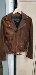 Pre owned. This is a rugged, looking, buttery soft motorcycle style jacket. It has an angled zip from closure. Zipper...