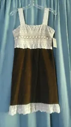 100% Cotton but the Brown fabric feels of a light velvet texture. Pretty lace accent on the top and hem. Side zipper....
