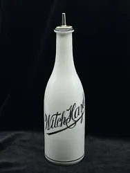 Early 1900’s milk glass “Witch Hazel” barber bottle. Black hand scripted lettering and bands at base and on lip....