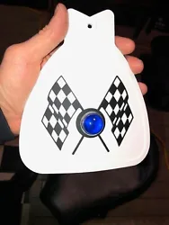 MUDFLAP IN WHITE WITH BLACK & WHITE CHECKERED CROSS FLAGS AND BLUE JEWEL. YOU GET ONE MUDFLAP IN WHITE. WITH CHECKERED...