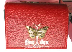 Beautiful Gucci leather wallet featuring a3D gold color moth / butterfly and the words GUCCI Garden in gold color on...