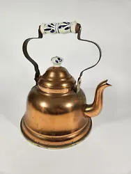 This vintage tea pot kettle is a unique addition to any collection. Crafted from copper, it features a white and blue...