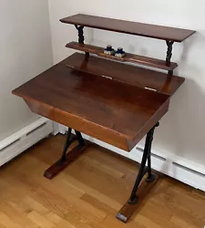 This is a beautiful antique 3-tiered school desk. Made of maple with cast iron legs and shelf brackets. The writing...
