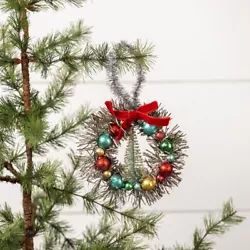 Add a touch of vintage charm to your Christmas decor with this beautiful wreath from Ragon House. The wreath features a...