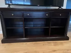 Dark Wood TV Stand for 65 inch TV. In good condition, no longer needed. VERY HEAVY.Please message me for any additional...