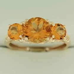 1.75 CT Genuine Citrine Center stone. 2.6 grams of 14K yellow gold. 0.96 CTW round citrines on sides.