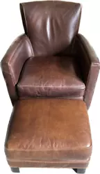 Beautiful Brown Leather Chair and matching Ottoman. Legs are solid Oak. Very light usage. They dont build furniture...