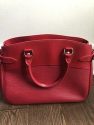 The bag features top rolled leather handles with silver links, side belts and silver buckles. Item Condition: Very...