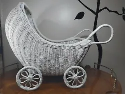 This vintage white wicker buggy is a charming addition to any collection. With a delicate wicker rattan material and a...