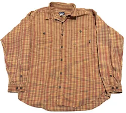 This Patagonia button-up shirt for men features a colorful plaid pattern that is perfect for any outdoor or casual...