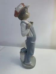 This beautiful Lladró figurine features a young boy wearing suspenders and playing the accordion. Its a perfect...