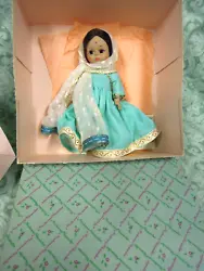 She is dressed in a aqua colored dress with trim; and a white net scarf. She has dark hair in original set. Pre-owned &...