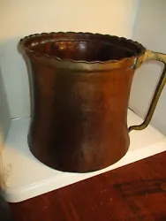 Copper cauldron/pot has a solid brass handle. Top rim is scalloped. Once used for making apple butter. Antique early...