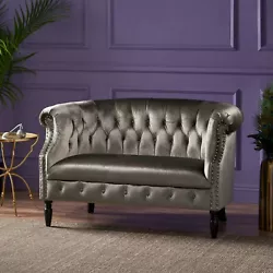 The antique stylings of this tufted loveseat add an unmistakable charm to any living room. Includes: One (1) Loveseat....