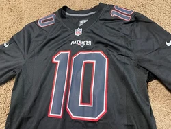 Represent your team in style with this officially licensed New England Patriots Mac Jones football jersey. The black...