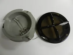 Lid attached to holder with cable.