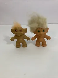 This is a lot of 2 vintage troll dolls from the 1960s. Both dolls have white and small amount of orange hair, with...