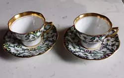 Pair (2) of elegant teacup and saucer with gold trim inside and outside cup and on handle, colorful black and white...