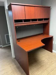 This corner style computer desk with tall storage hutch is has a cherry finish and is in excellent condition. 