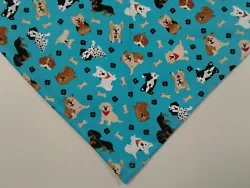 Custom made machine washable cotton blend dog bandana is designed to tie-on. Pattern: Blue with dogs, bones, and paw...