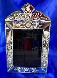 This is on a hardwood back, wonderful quality. It features a sturdy easel for displaying. Venetian Mirror !