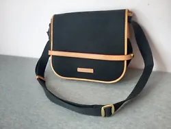 Dooney & Bourke Cabriolet Black and tan Canvas Messenger Bag. Condition is Pre-owned. Shipped with USPS Ground...