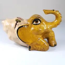 Painted paper mache with a gloss finish. Interesting and unique yellow / gold elephant with flowers & abstract dragon...