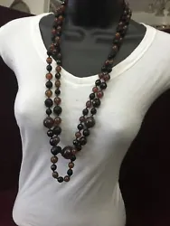Vintage Amber & Garnet Colored Glass Necklace Heavy 64 Inches Long Beautiful. Several different sized beads with knots...