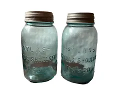 Two Vintage Atlas rounded Strong Shoulder light blue Mason fruit jar, quart-sized. Includes pair of milk glass lids....