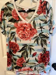 Polyester spandex. light blue & white stripes with large floral print. V-neck, short sleeves, slight hi low hem....
