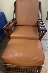Large Rattan Chair and ottoman with leather cushions in very good condition. This item is available for local pick up.
