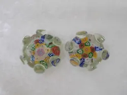 Millifiori pattern of red, blue, yellow and green. Unusual round-shaped glass paperweights with 6 attached or...