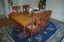 Great candidate for restoration. Solid oak and nicely styled. Table with two leaves and four chairs. Table with some...