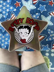 This collectors item features Betty Boop miniatures in a tin from 2002 by Carlton Cards. The tin showcases the iconic...