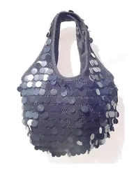A hand crocheted bag with black sequin paillettes for a glamorous style.