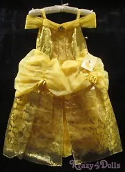 Billowing yellow organza top skirt with gold glitter trim and yellow satin rosette accent. Back of bodice features four...